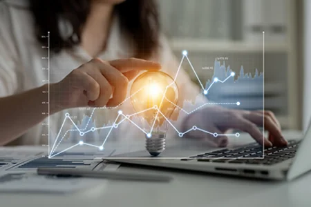 We make BI technologies usable – through our BI consultancy services Iconic image: hand typing on laptop, with lines and a light bulb above it to symbolise a BI idea.