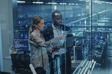 Identifying potential, developing solutions – with our AI consultancy Iconic image: Two people with laptop doing an AI consultation in front of server racks behind glass